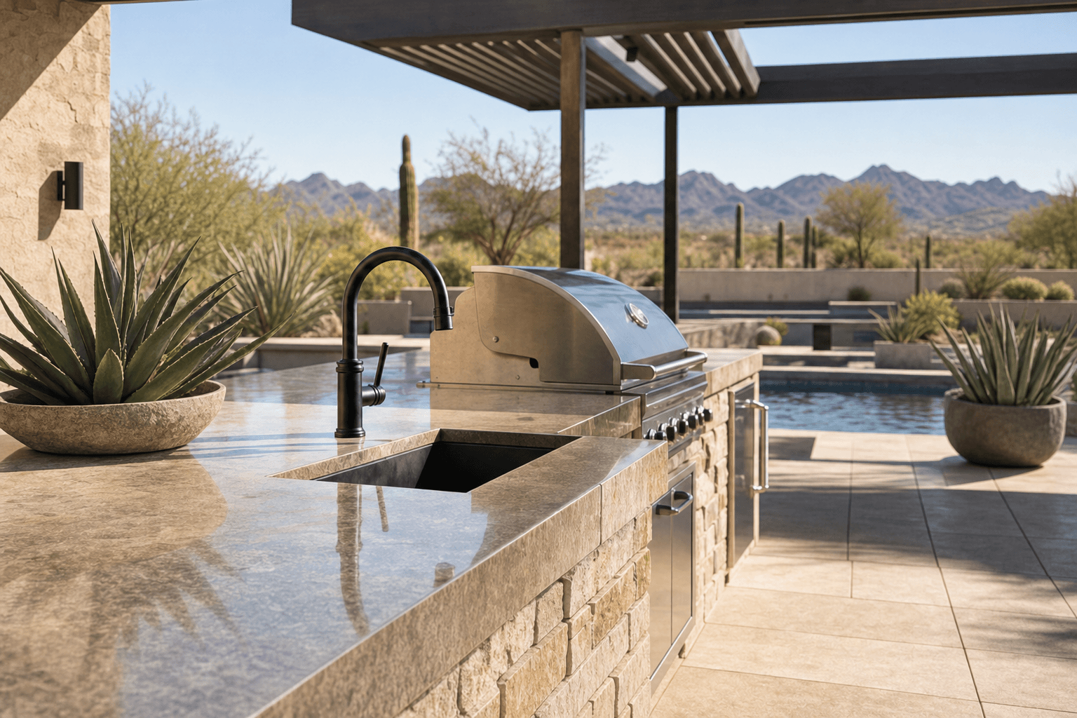 Outdoor kitchen counter, grill, sink, and mountain view