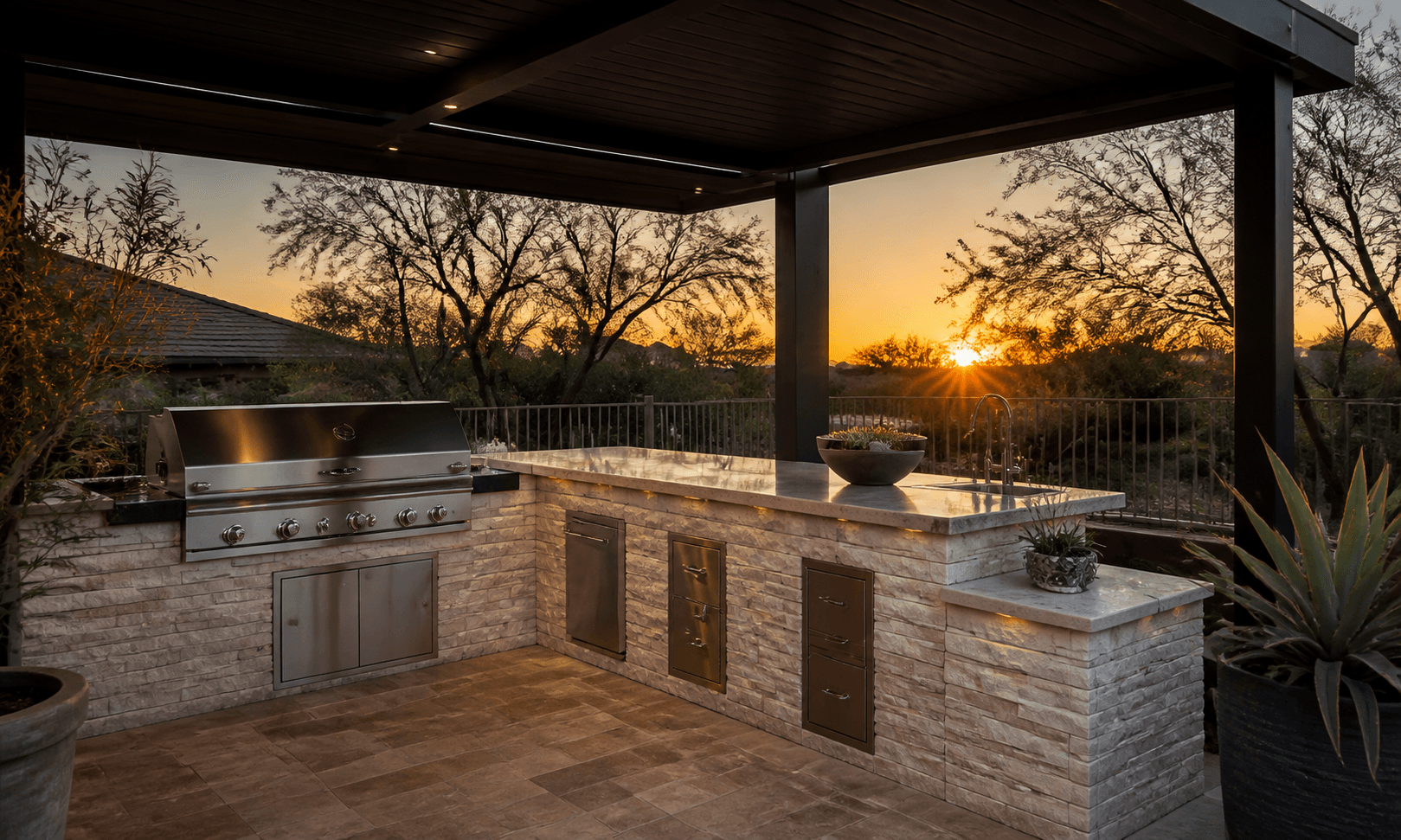 Covered stone outdoor kitchen at an Arizona sunset
