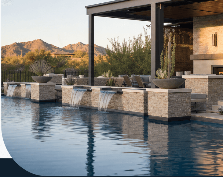 Pool with stone scupper walls, a shaded patio, and desert mountains